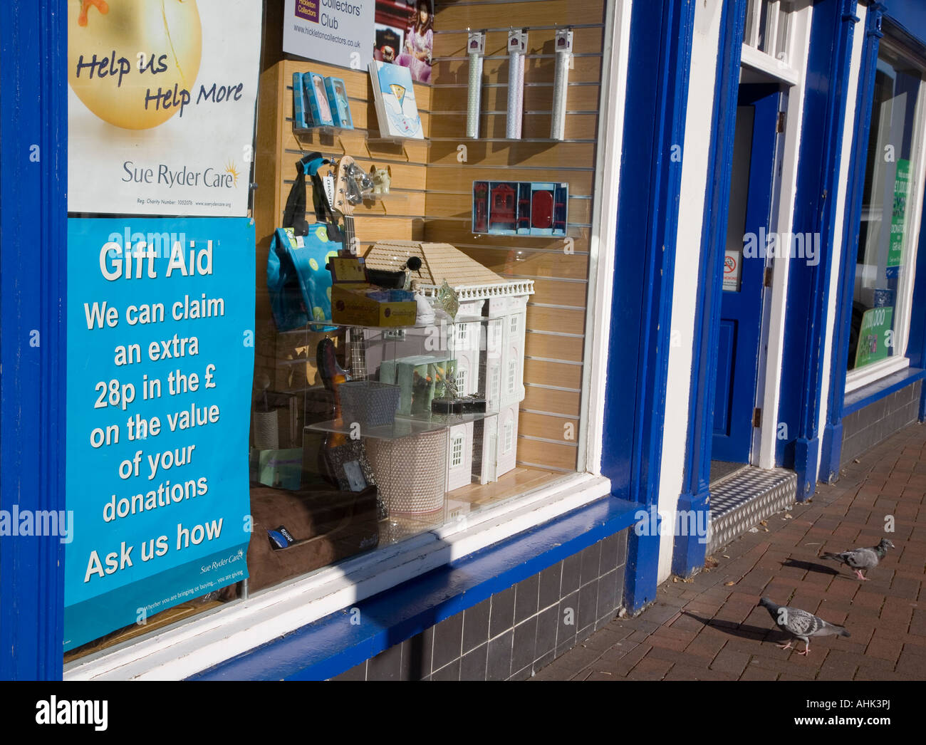 Charity shop with gift aid poster in window Wales UK Stock Photo