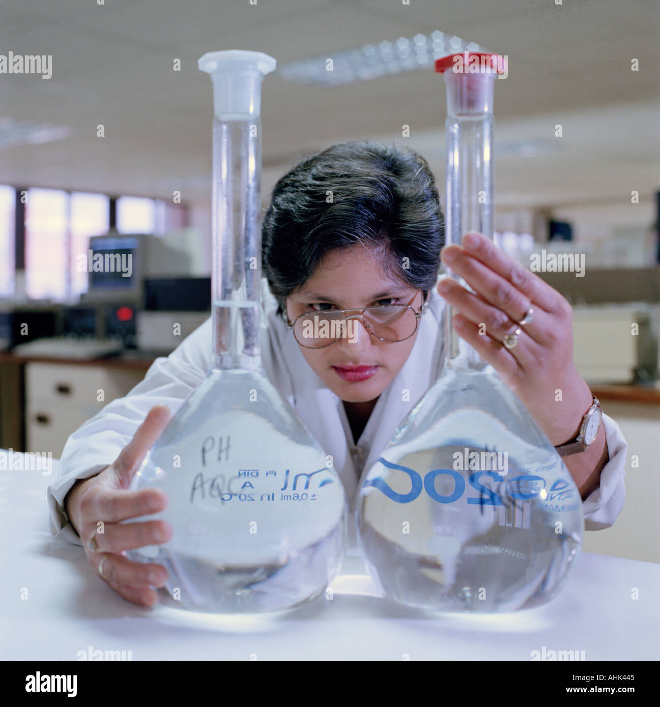Female technician in a water monitoring laboratory tests the purity of