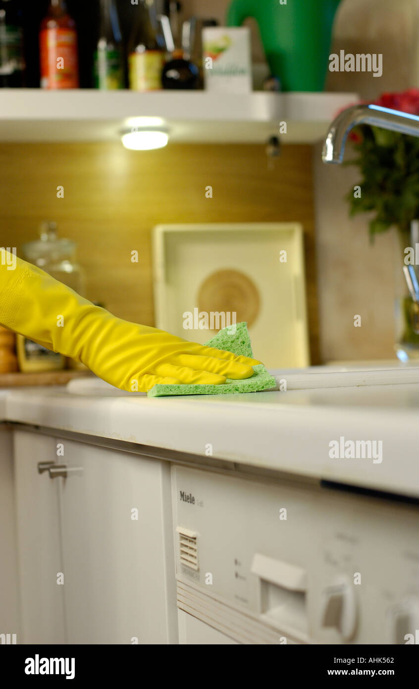 cleaning the kitchen wearing rubber gloves Keywords Domestic Chore