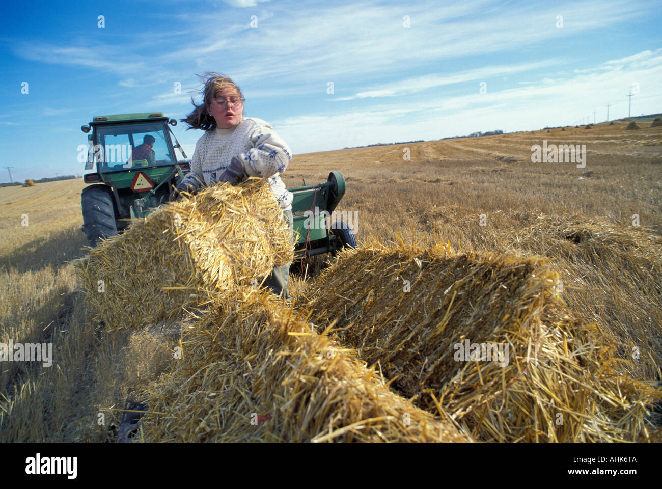 Canada Manitoba MR Karla and Corey Nychuk work on hay bailer at family farm in town of Vista Stock Photo