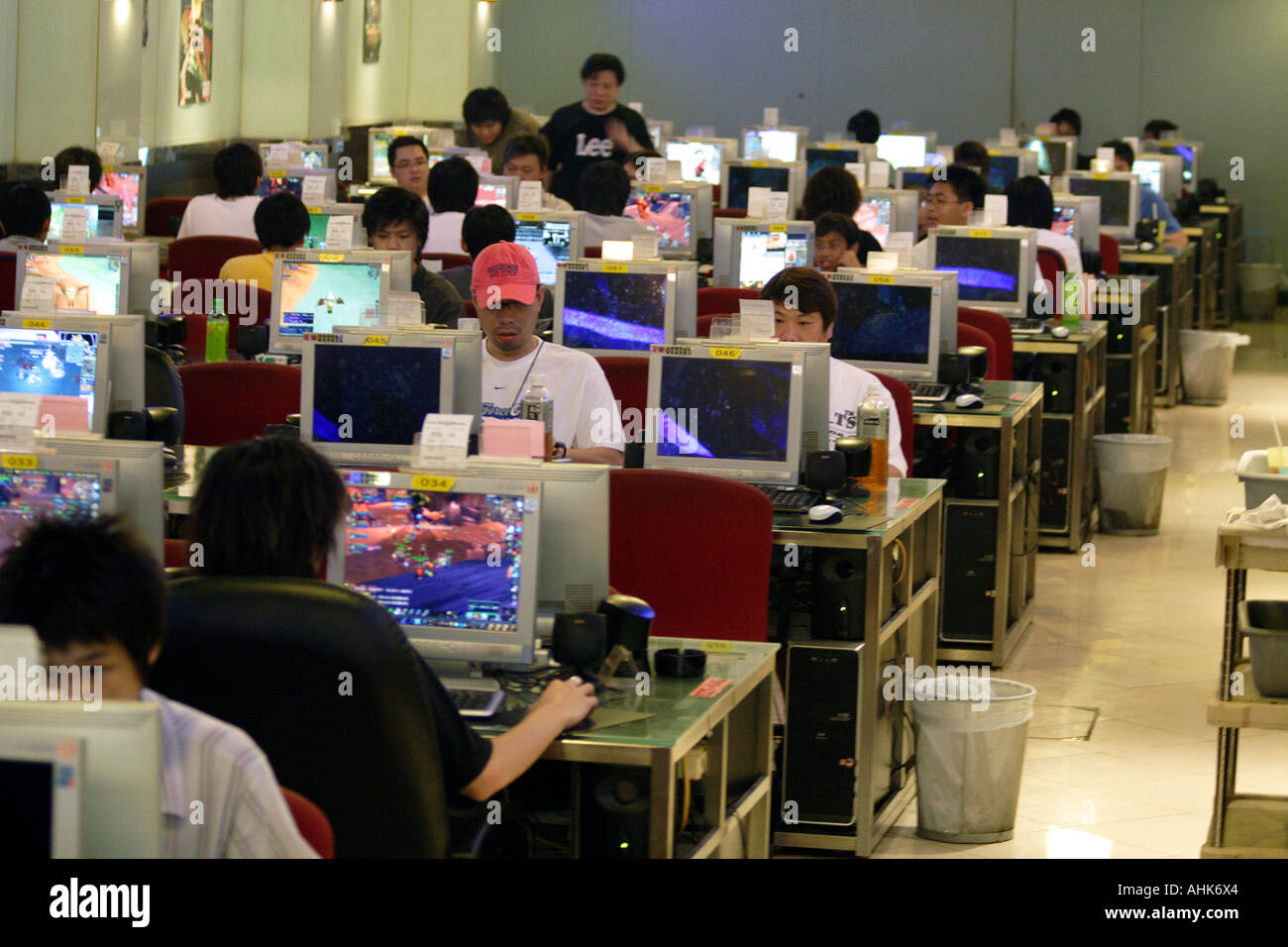 Young Chinese People Playing Online Video Gaming and Surfing in an Internet Cafe, Hong Kong, China Stock Photo
