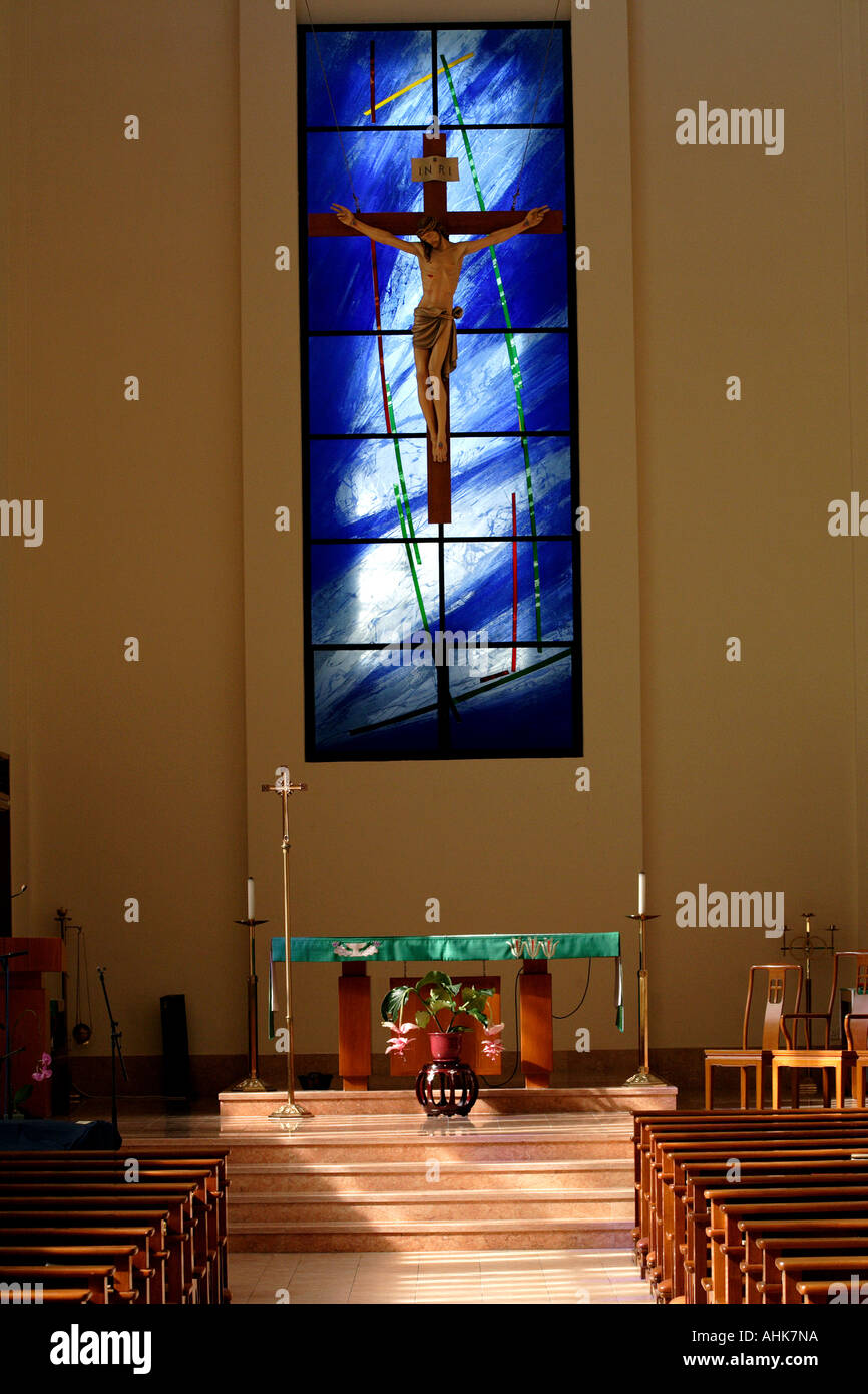 Alter and Wooden Pews at a Christian Church and a Blue Stained Glass Window Stock Photo