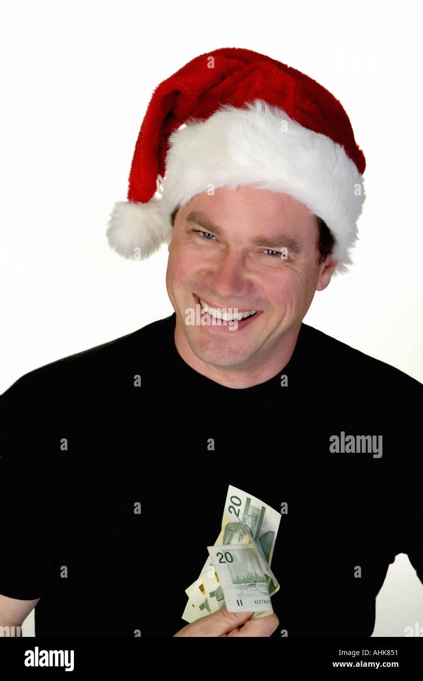 Man in Santa Claus toque with some money Stock Photo