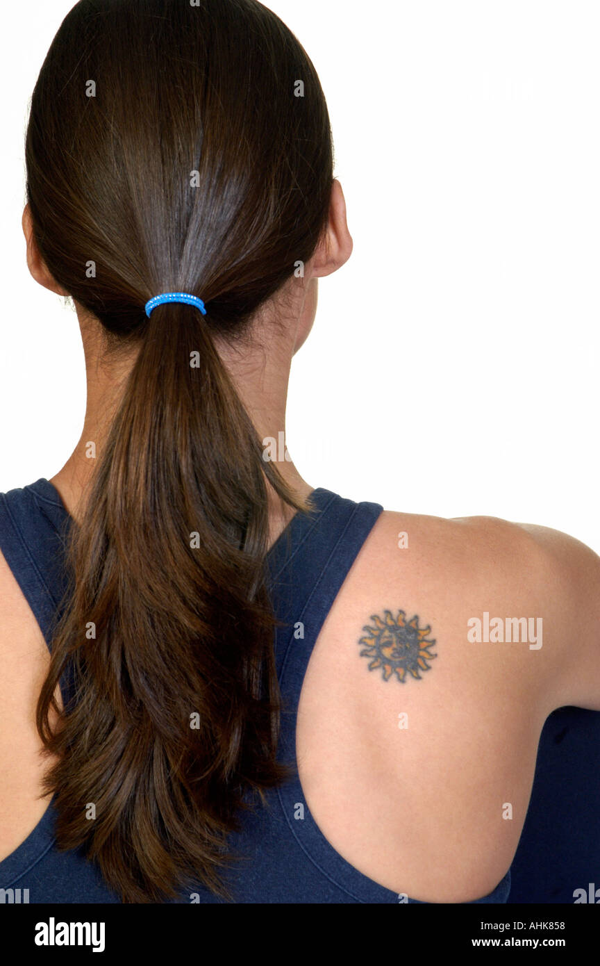 Sun tattoo on woman s shoulder Stock Photo
