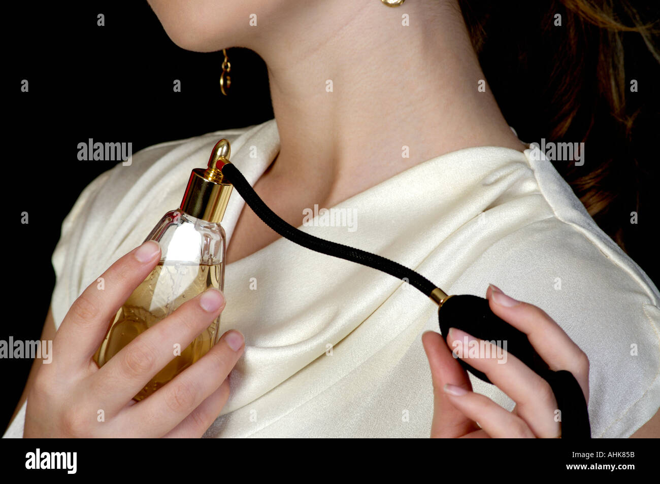 Woman applying perfume Stock Photo