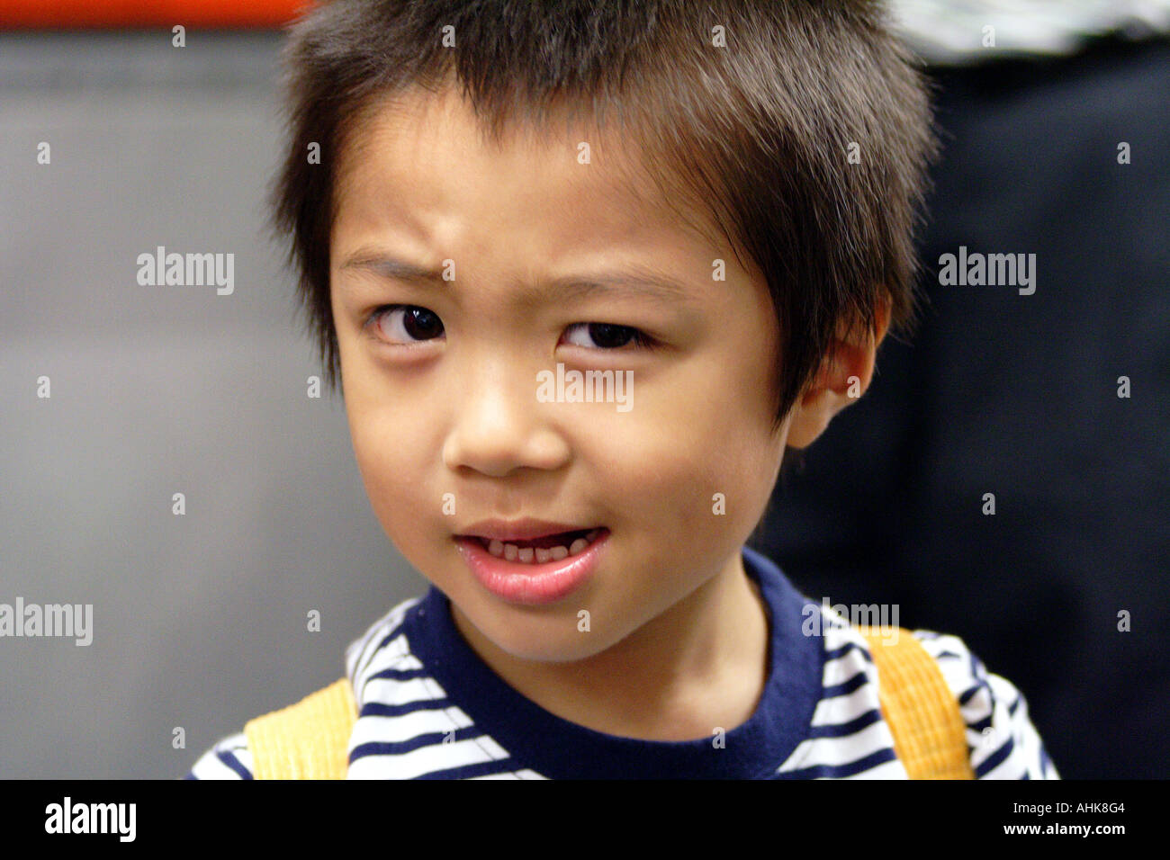 Cute Young Asian Boy Making Faces, Hong Kong Stock Photo