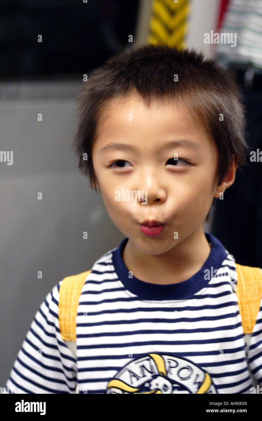 Cute Young Asian Boy Making Faces, Hong Kong Stock Photo
