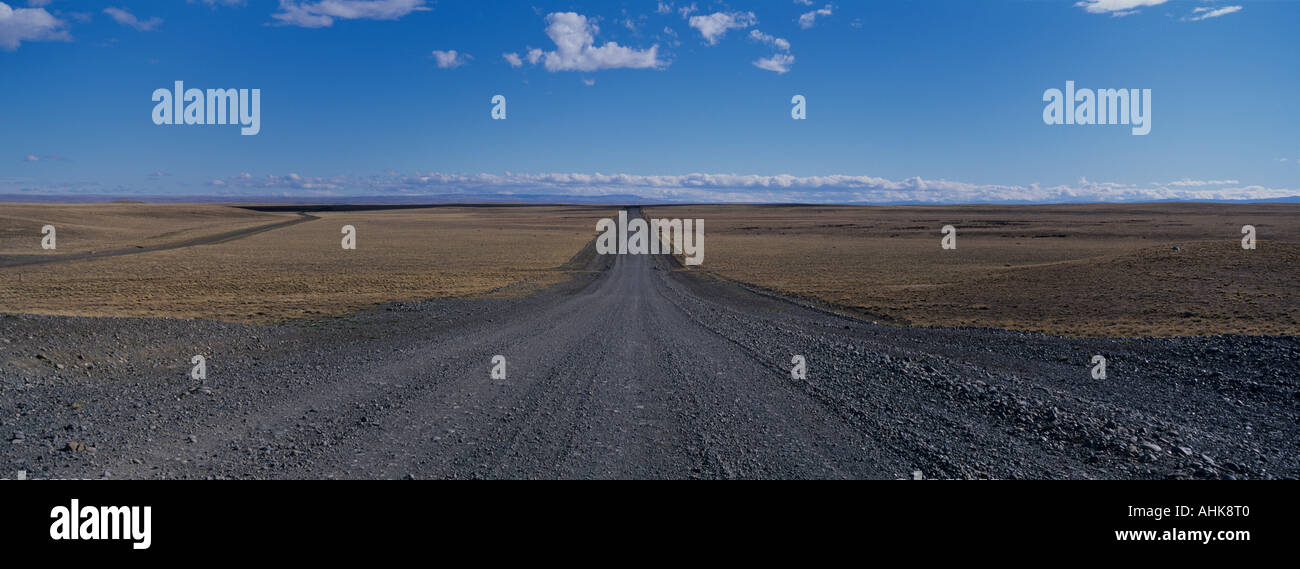 Argentina Empty gravel road stretches for miles across flat grasslands ...