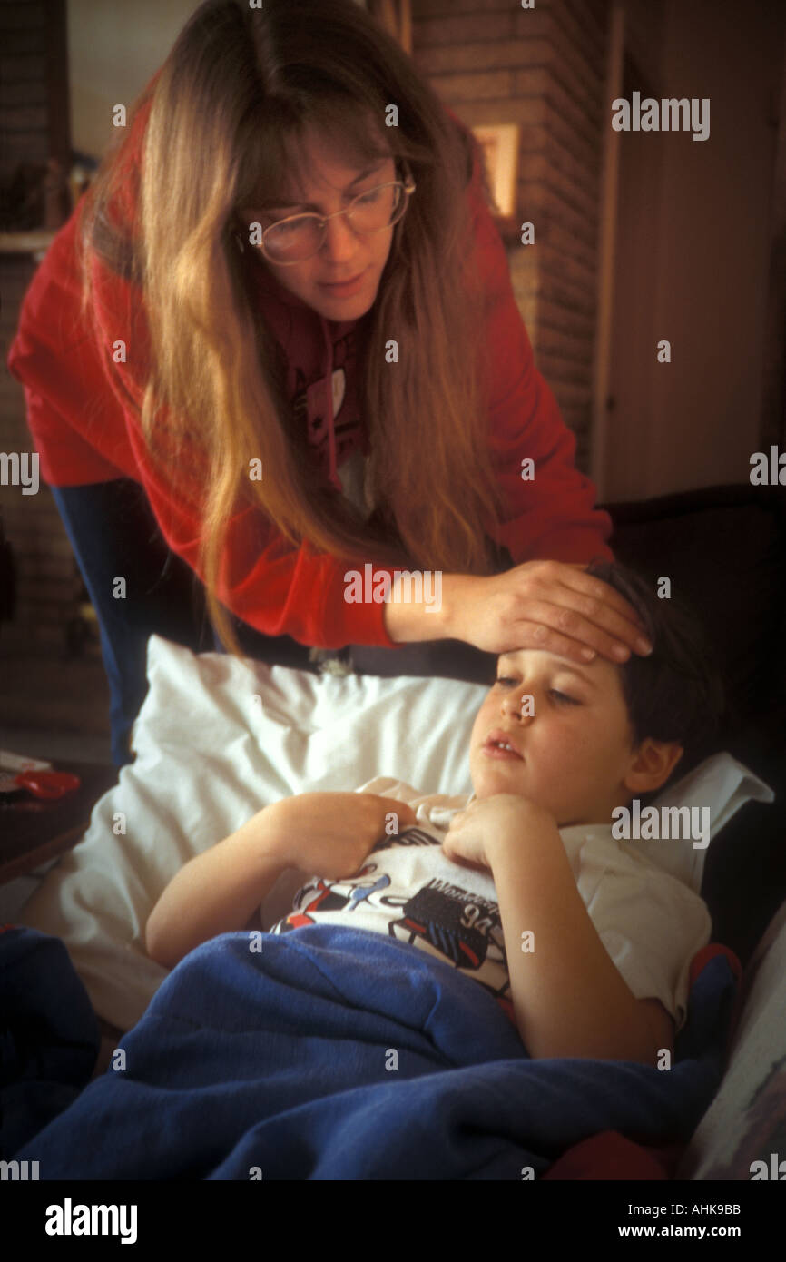 Mom Feeling Child's Forehead for Fever Stock Photo Alamy