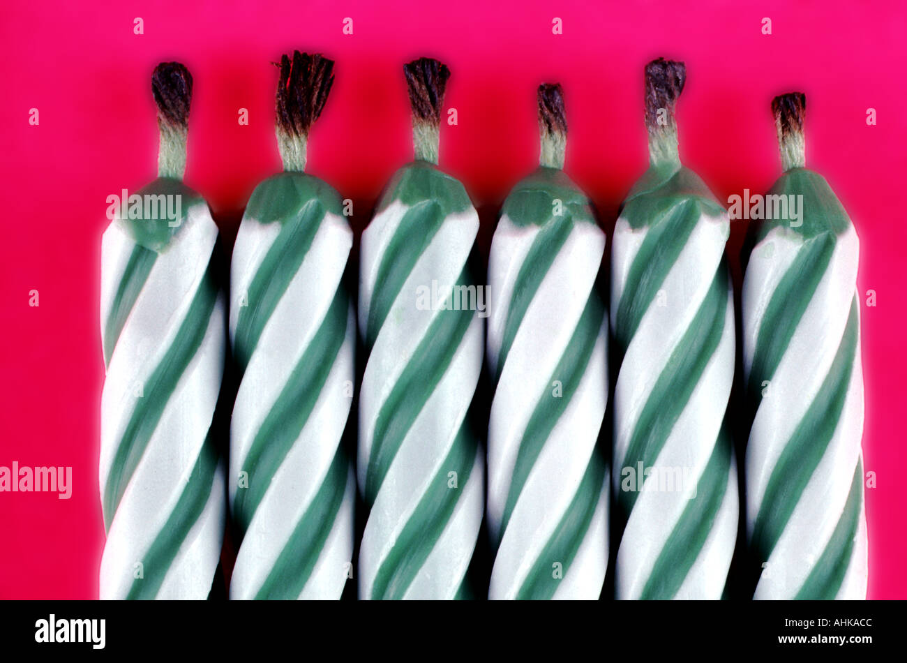 Green and white candles with burnt wicks close up Stock Photo Alamy