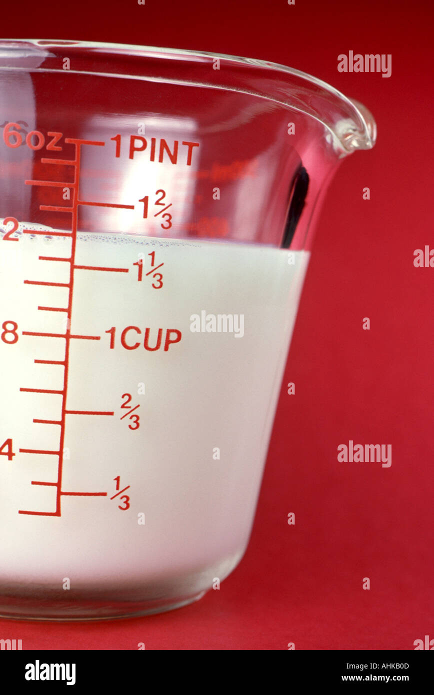 Milk in a glass measuring cup Stock Photo - Alamy