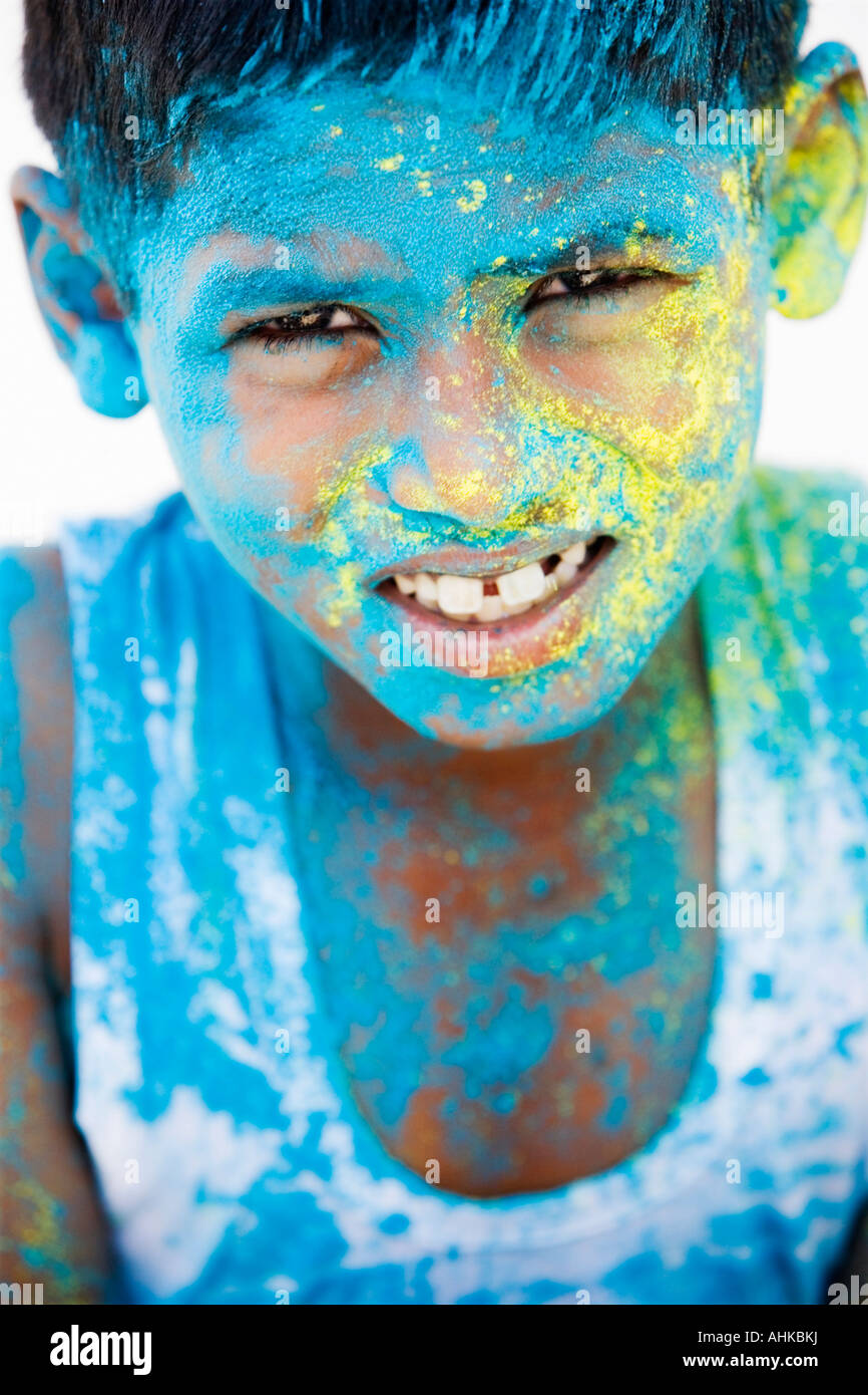Indian boy covered in blue yellow powder. India Stock Photo