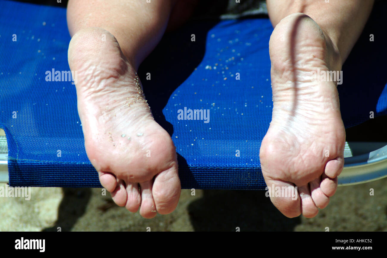 Pair of feet laying in Sun skiathos Stock Photo