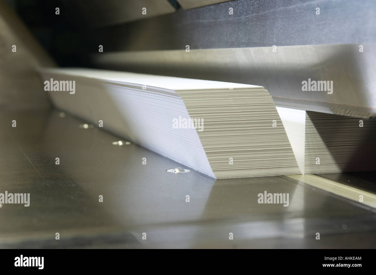 Paper being cut in guillotine Stock Photo Alamy