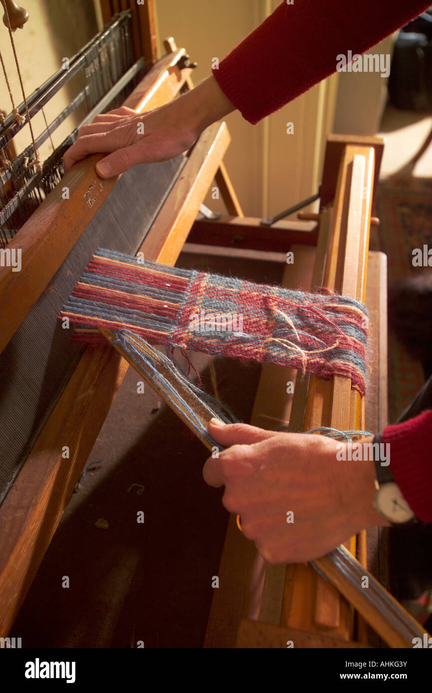 Weaving wool on loom Stock Photo Alamy