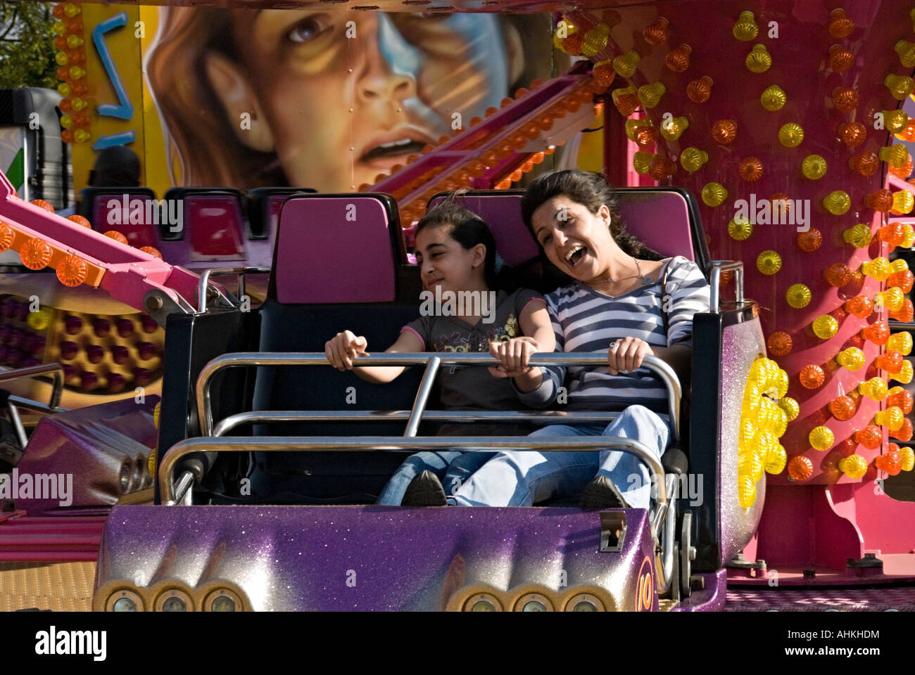 Woman and child enjoying a funfair ride Stock Photo - Alamy