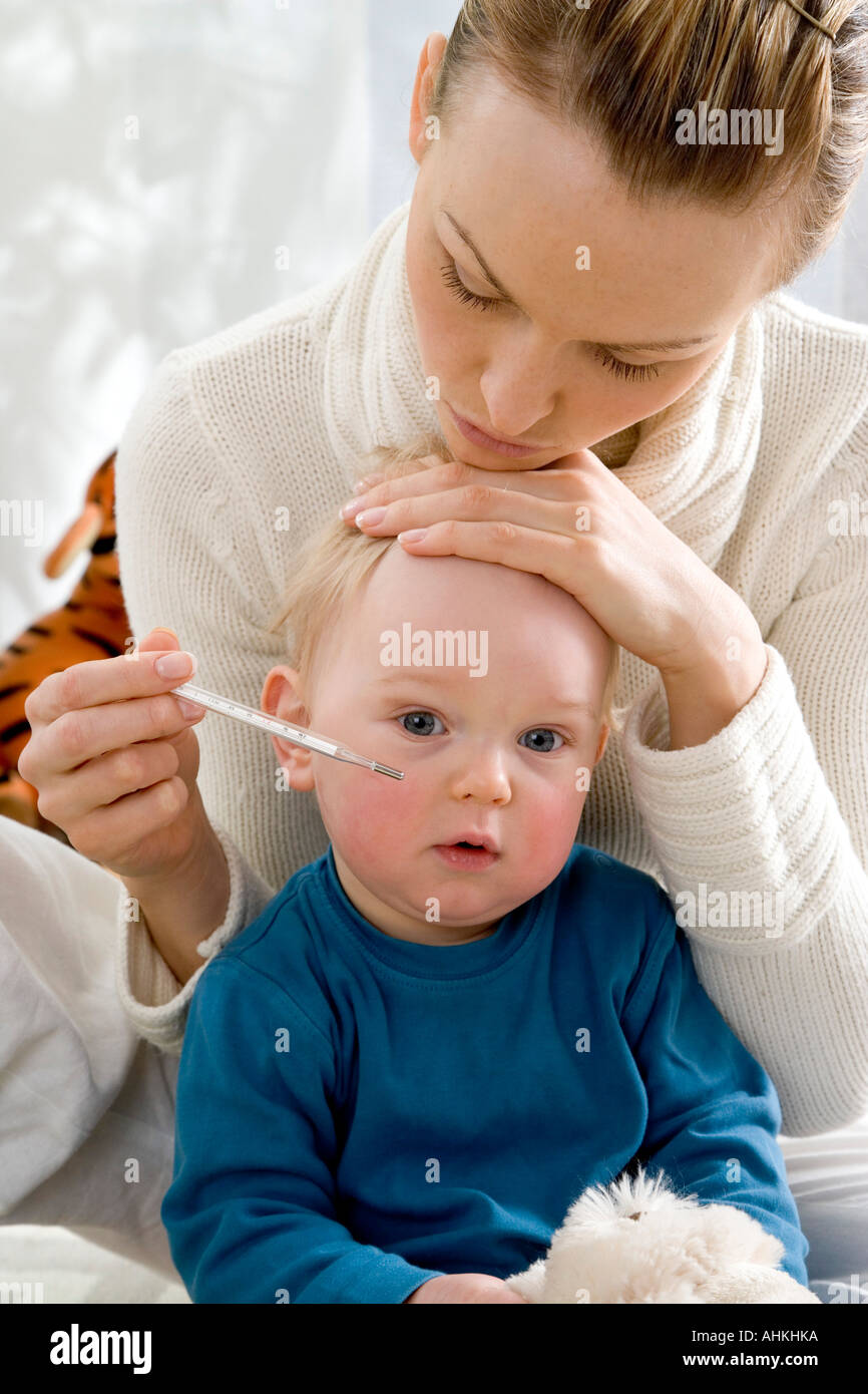 mum measuring son body tempature Stock Photo Alamy