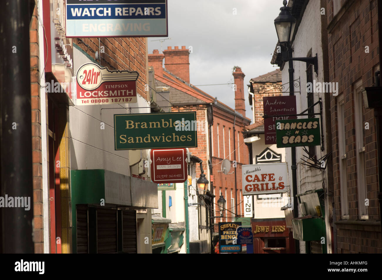 narrow street with many shop signs competing for attention City centre