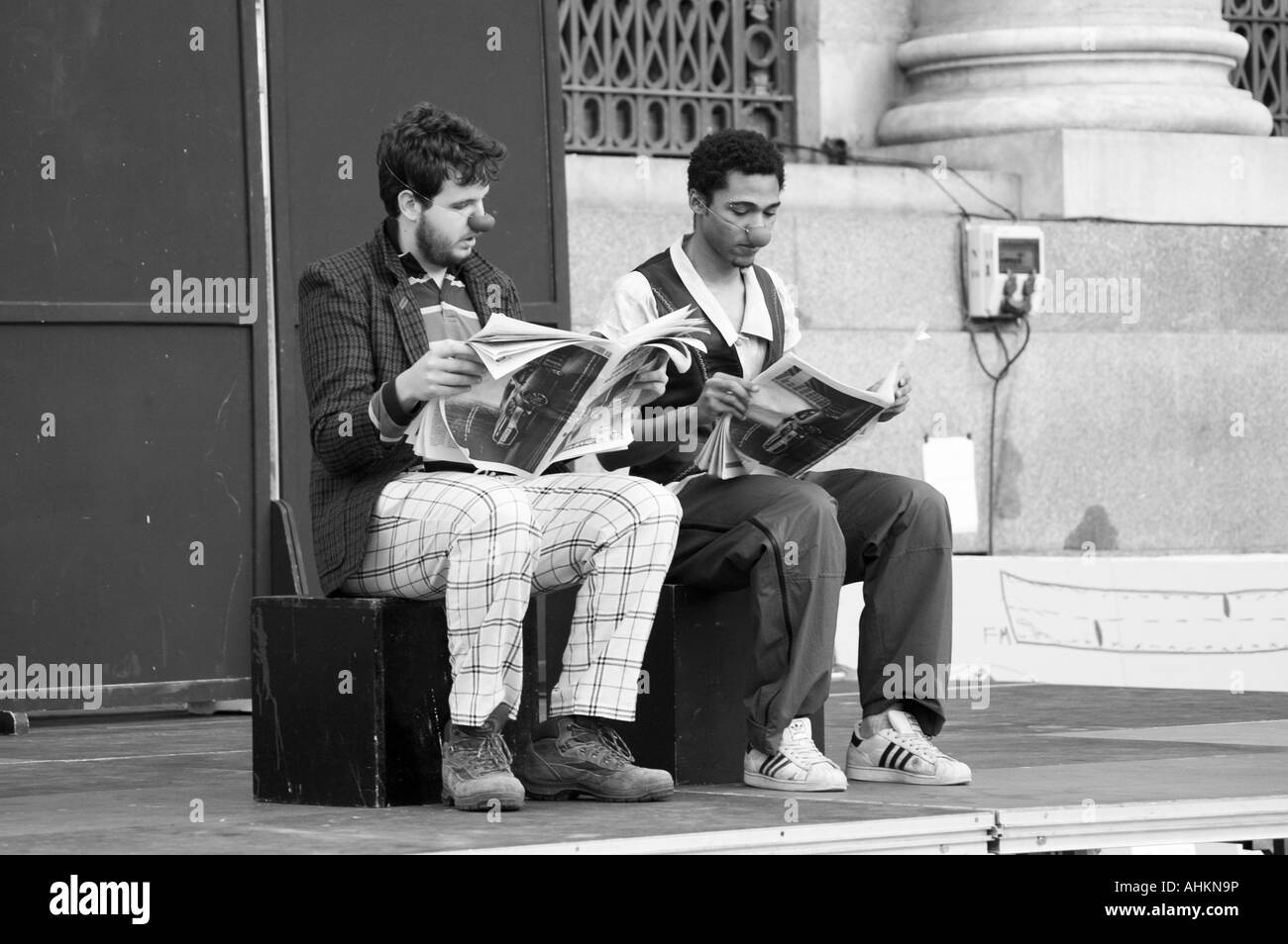 Clowns reading the diary in a street contemporary dance & theater festival.  Spain Square, Zaragoza, Aragón, Spain. Stock Photo
