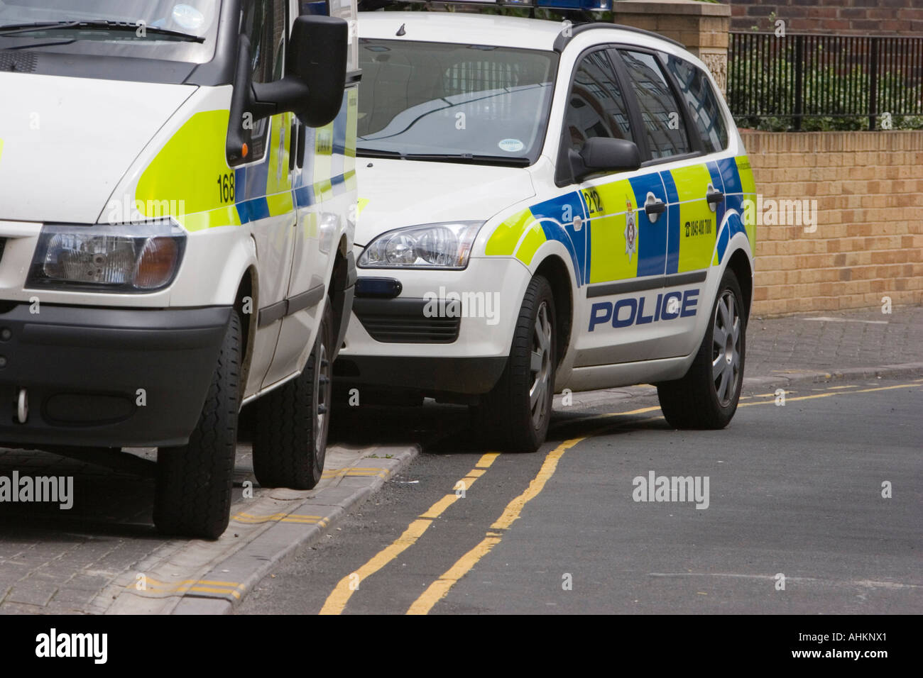 Police vehicles parked on double yellow lines Stock Photo