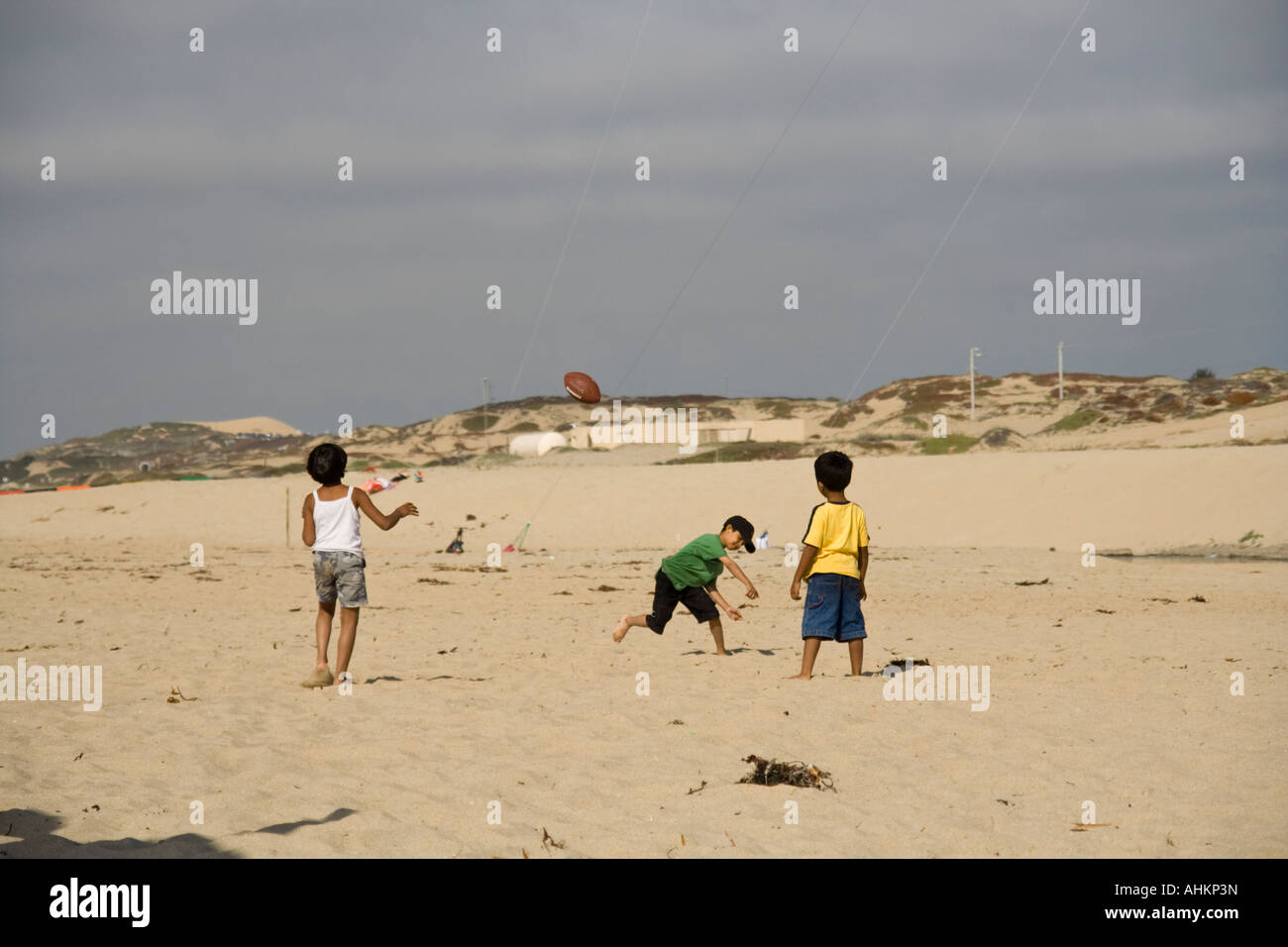 Children play American football on the beach Stock Photo Alamy