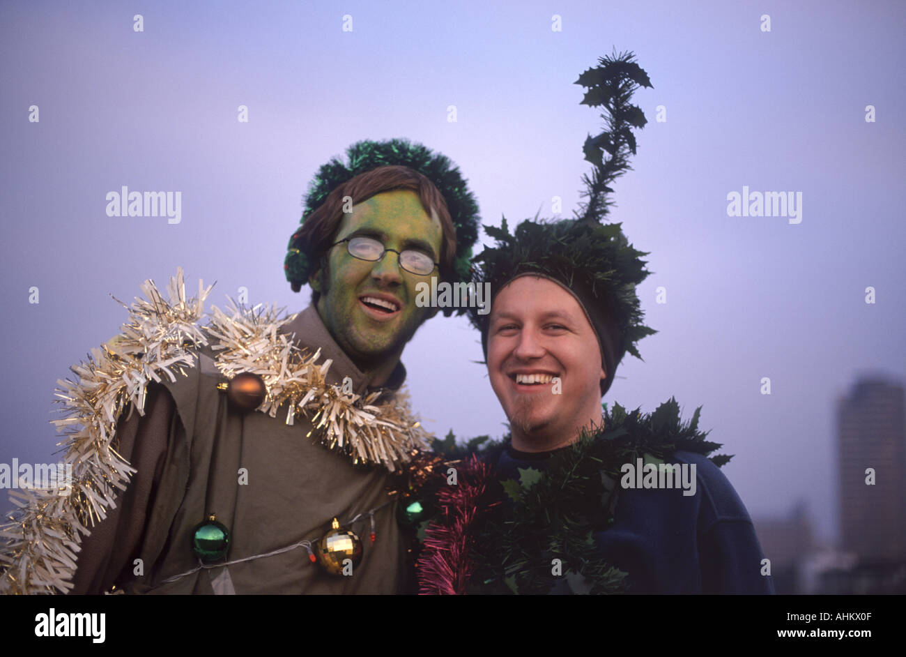 Two young men dressed as Christmas trees on Waterloo Bridge doing a charity walk across the bridges of London, England Stock Photo