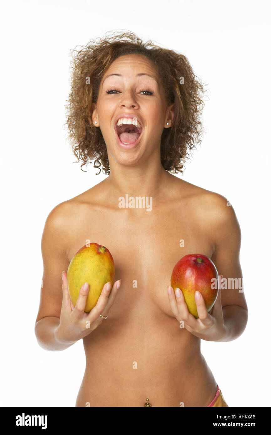 Mixed Race Woman Holding Mango to Cover Breasts Stock Photo - Alamy