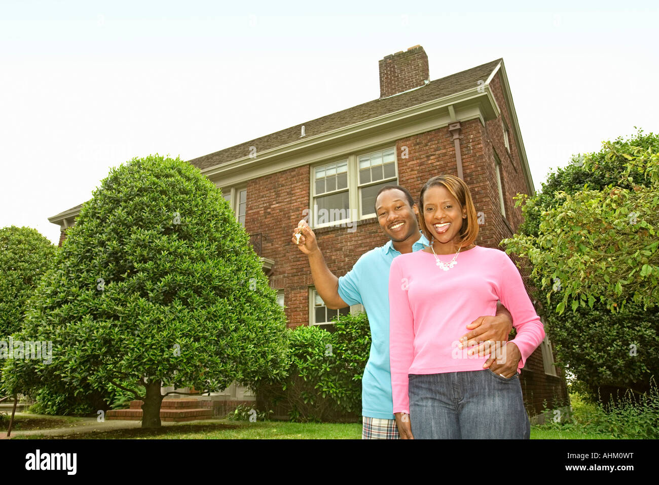 African couple in front of new house Stock Photo - Alamy