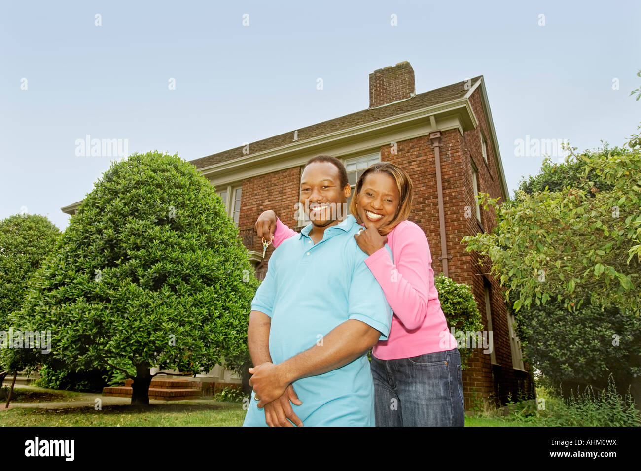 African couple in front of new house Stock Photo - Alamy