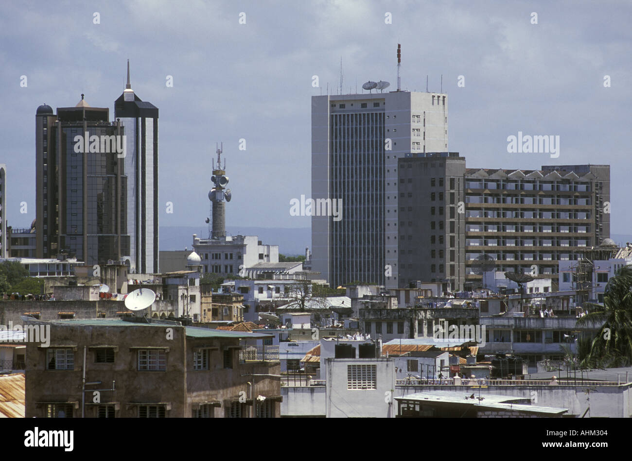 Modern high rise buildings seen over the roofs of the old town in Mombasa Kenya East Africa Stock Photo