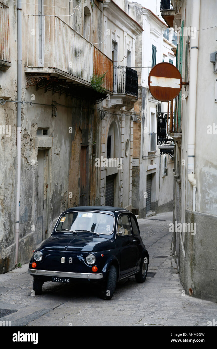 Old car driving at a narrow street in Ragusa Ibla Ragusa Sicily Stock