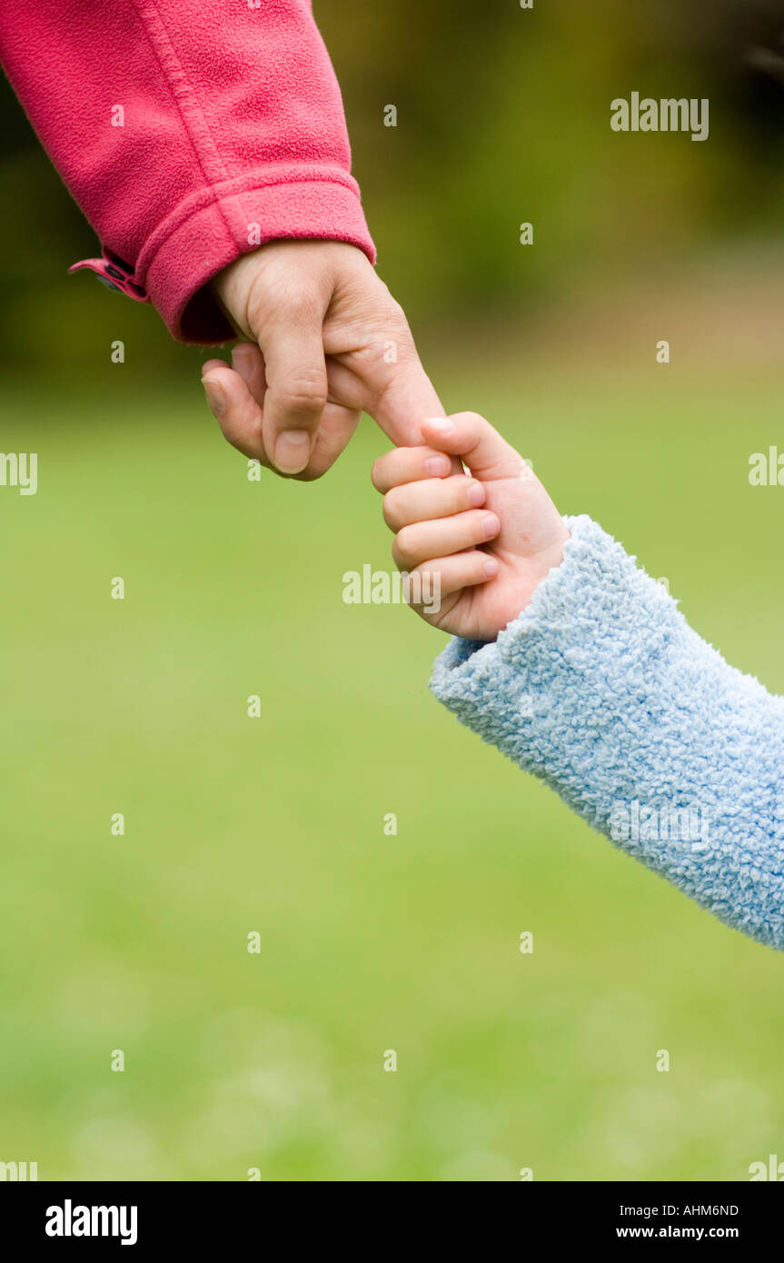 Child holding finger of mother s hand Stock Photo