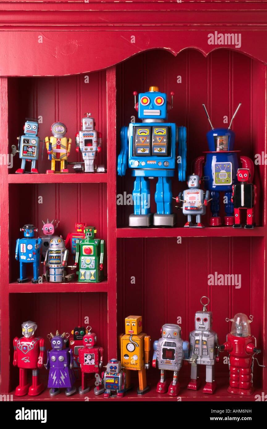 Red book case full of toy robots Stock Photo