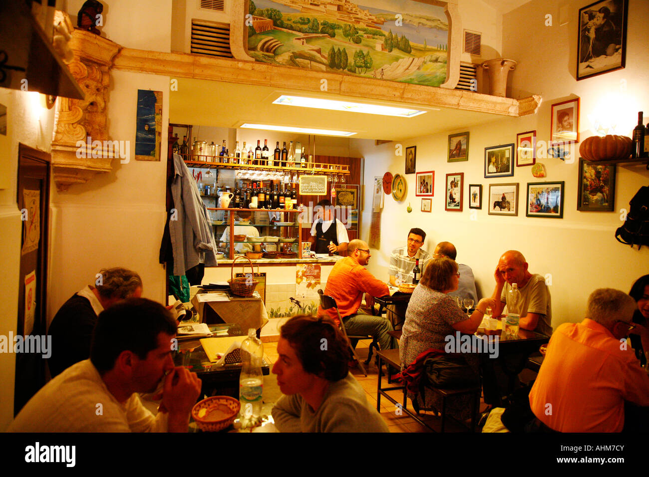 People sitting at a local restaurant in the historical area of Ortygia Syracuse Sicily Stock Photo