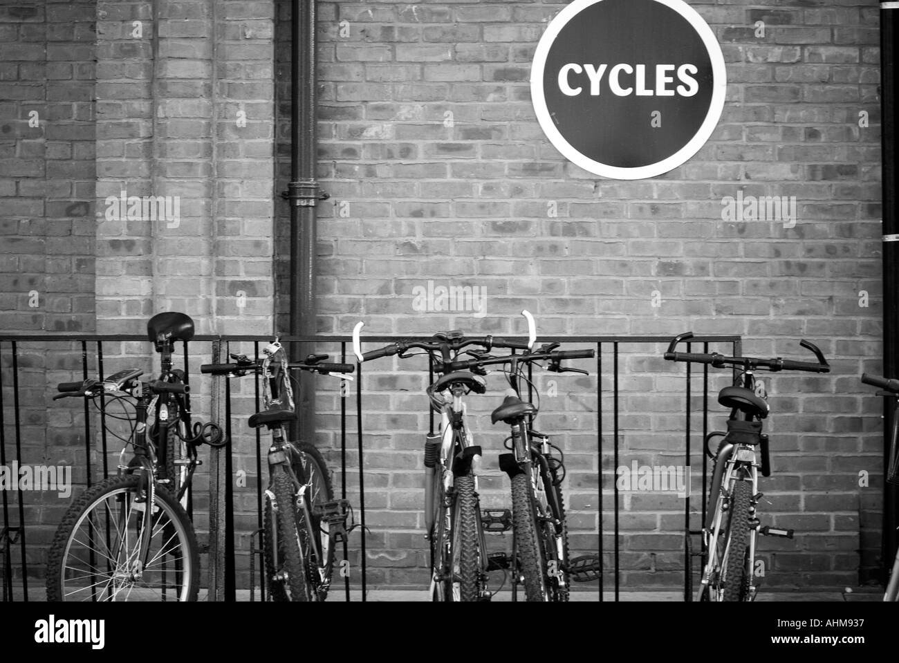 Bike rack cycle park green transport zero 0 emission vehicle pollution local journey mountain bike travel lock Stock Photo