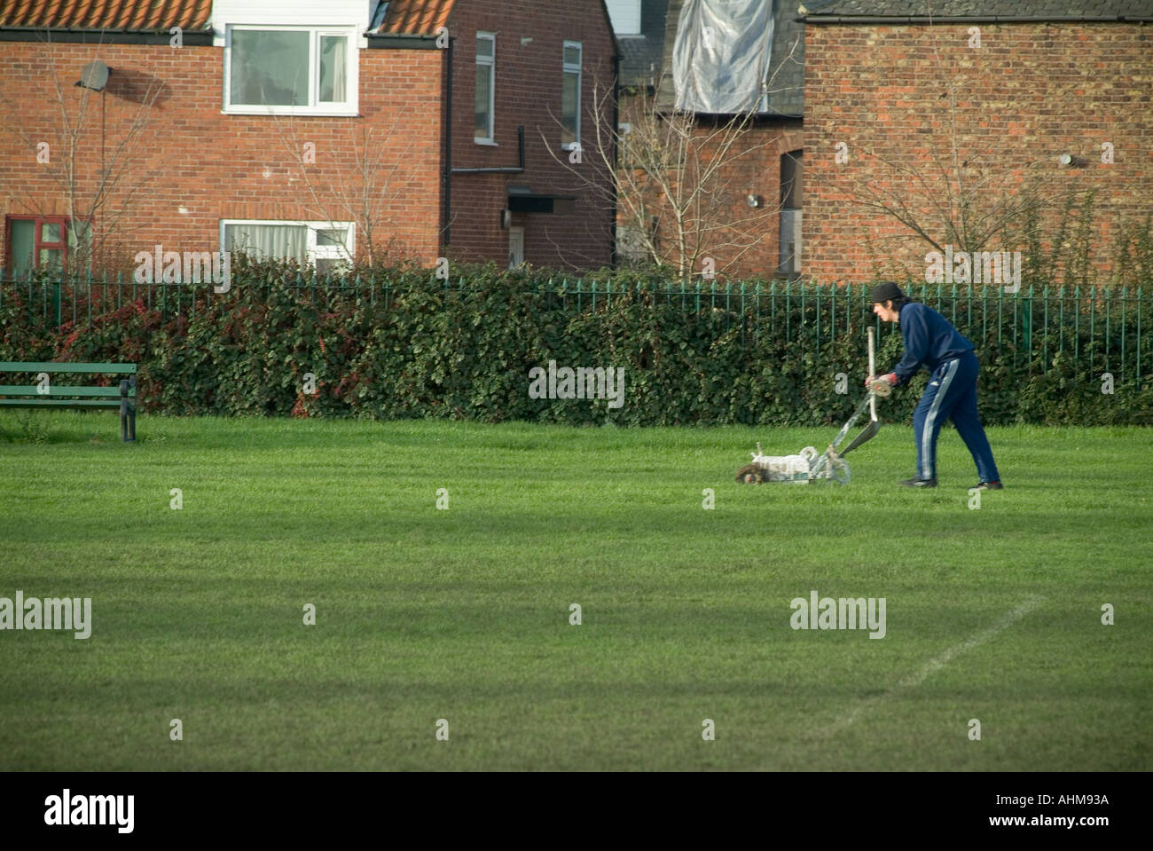 groundskeeper painting the white lines of a football pitch manual Stock