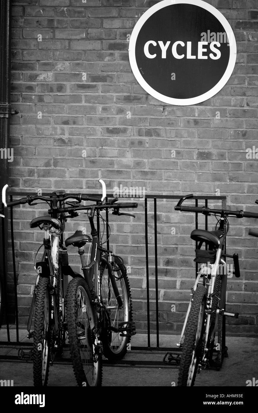 Bike rack cycle park green transport zero 0 emission vehicle pollution local journey mountain bike travel lock Stock Photo