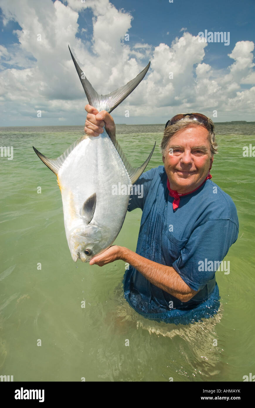 Florida Keys Mature fly fisherman releasing large Permit fish caught