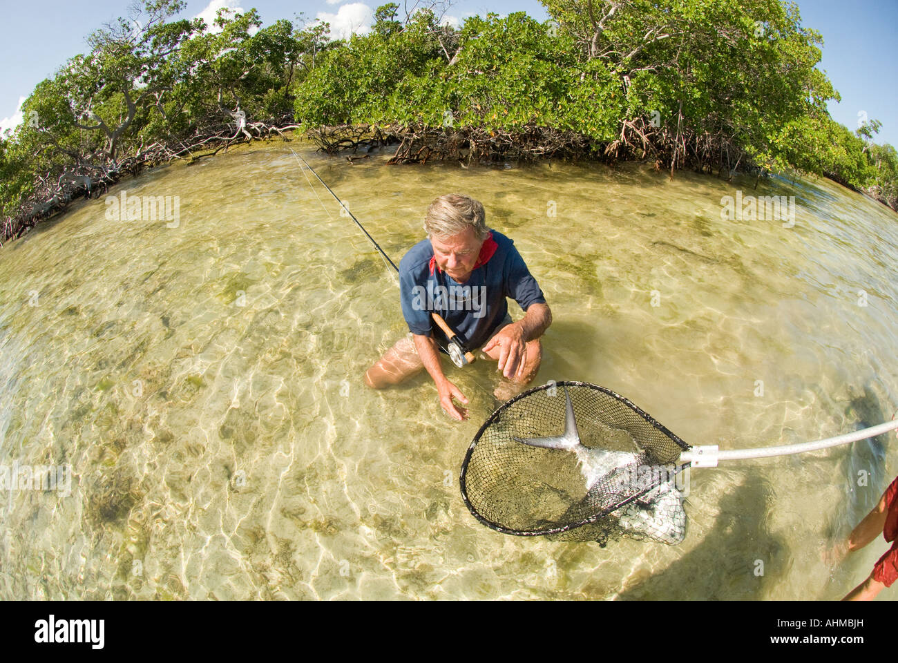 Florida Keys Mature fly fisherman ready to release Permit caught while