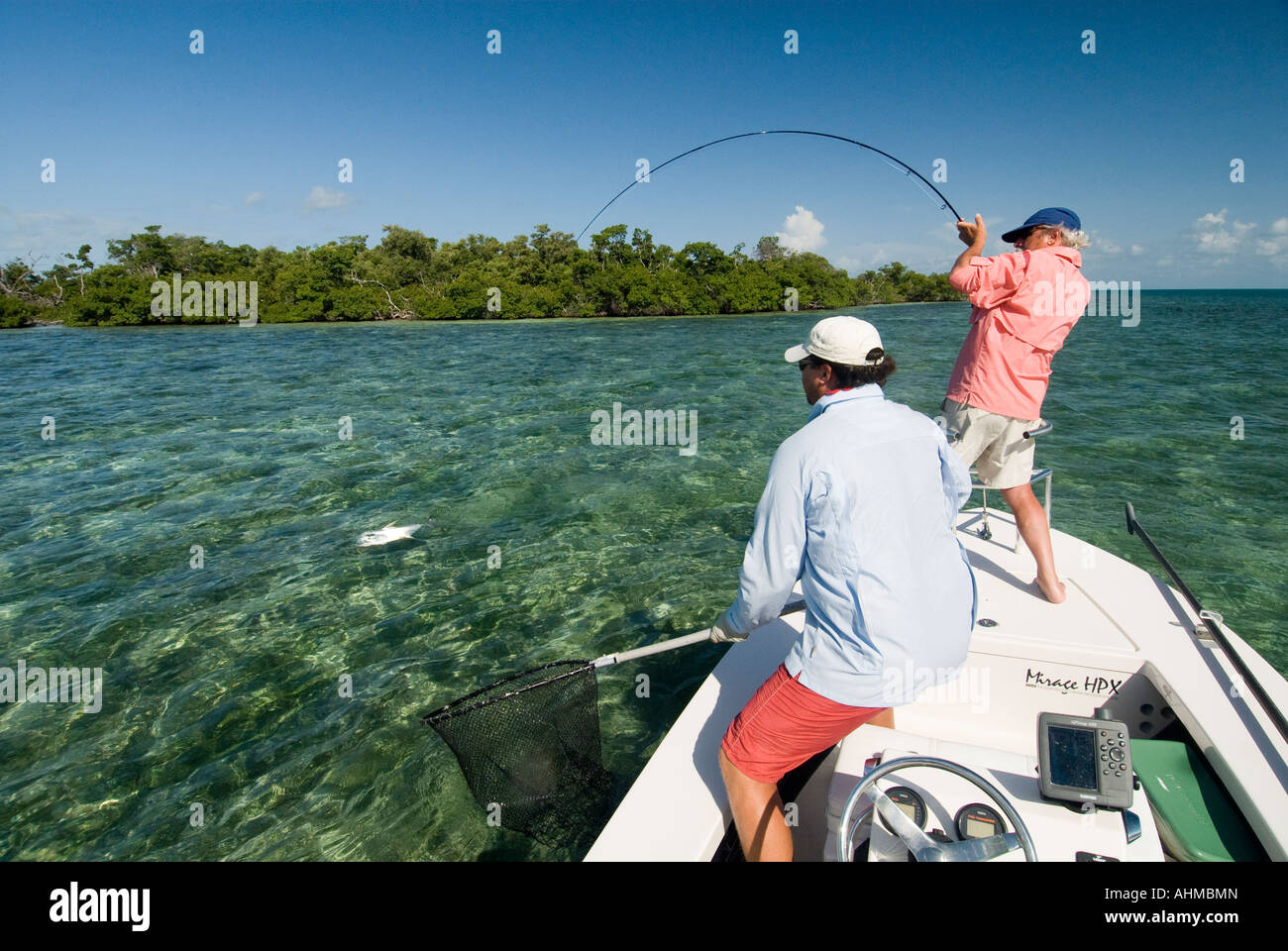 Florida Keys Fly fisherman fighting a Permit with help from guide on a