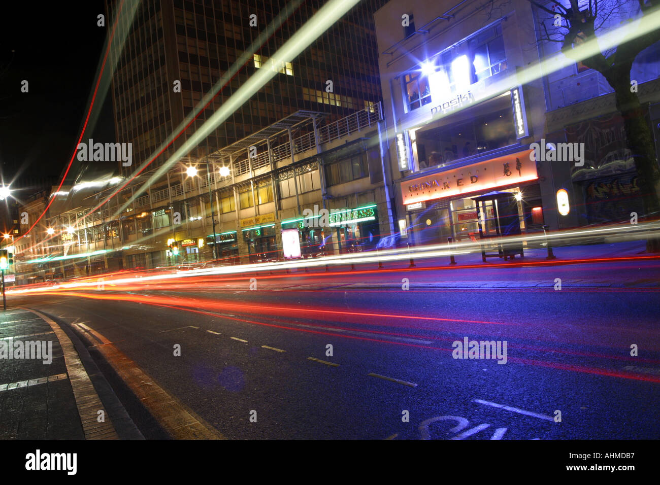 Traffic on a busy street showing traffic trails from the car lights at night Location is Broad