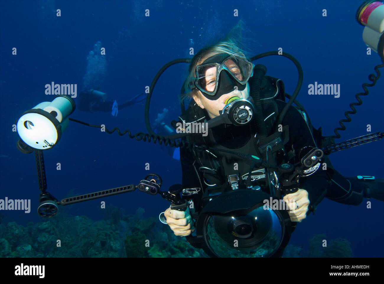 Underwater scuba diving photographer holding camera in housing Stock Photo