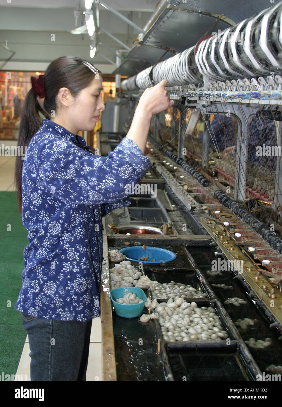 Female worker in a silk factory in Shanghai Stock Photo
