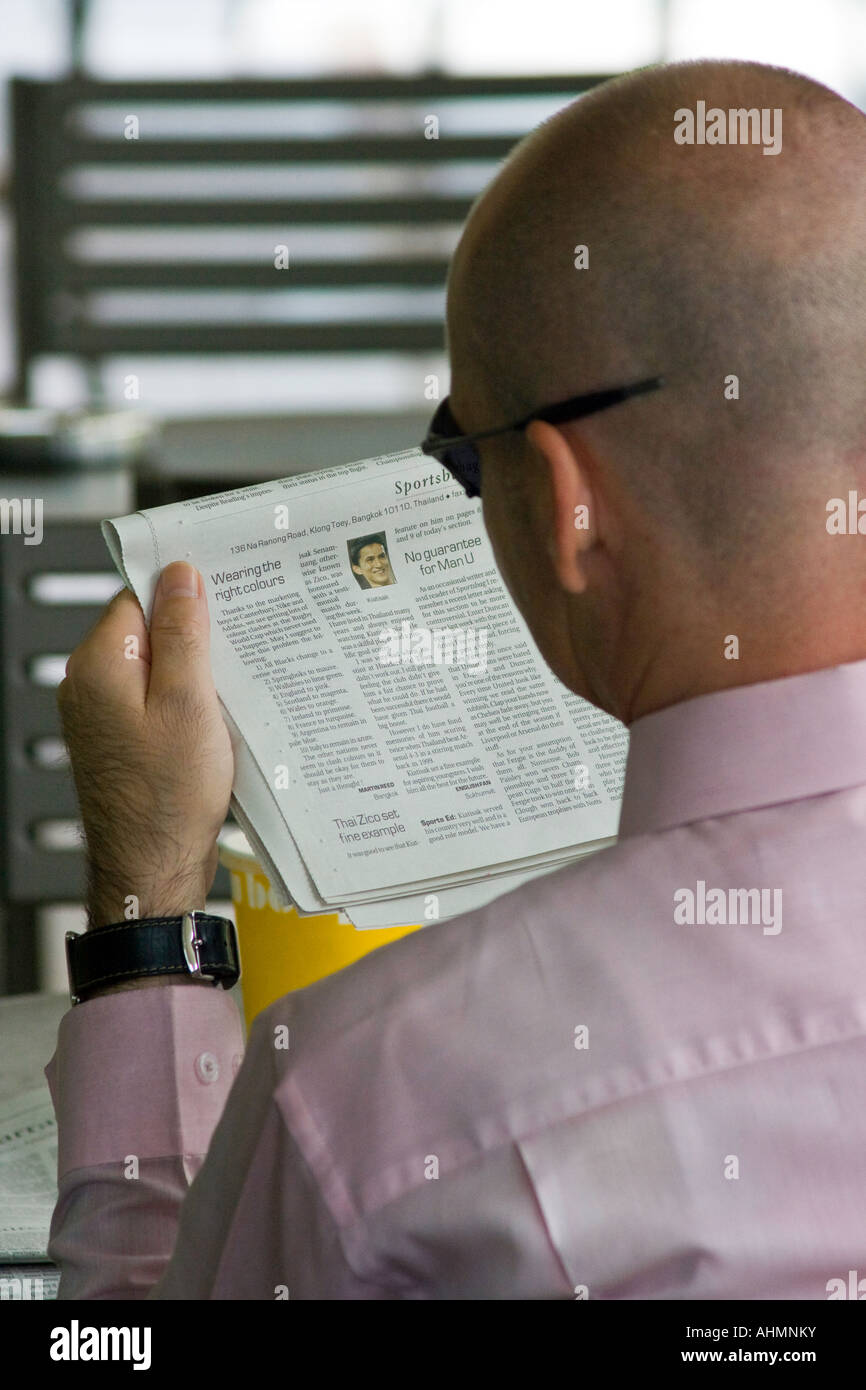 Young Professional Western Expat Man Reading Newspaper Bangkok Thailand Stock Photo
