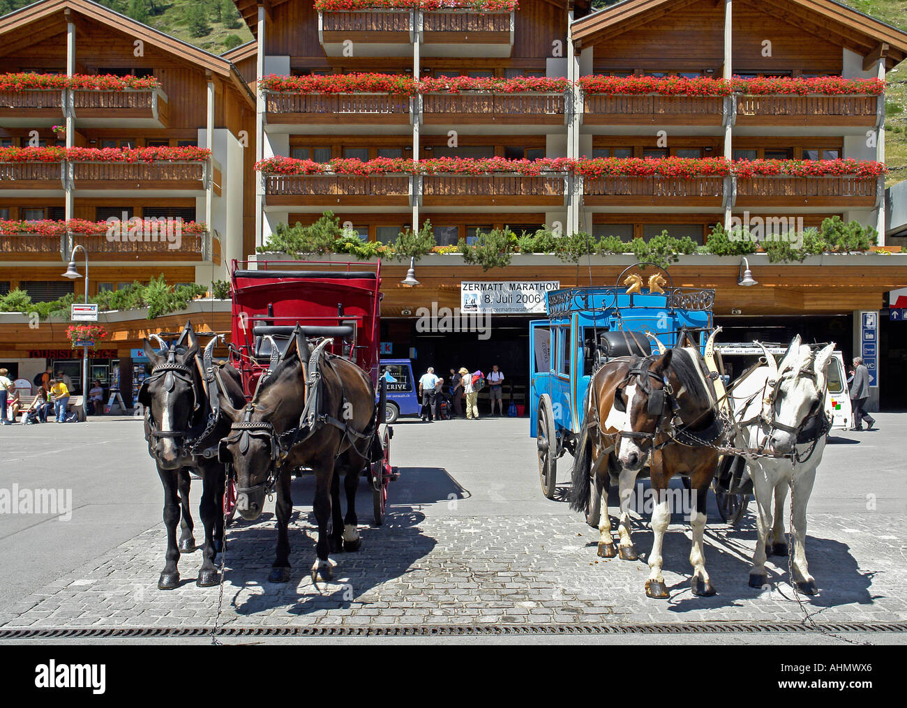 Horse drawn carriages waiting for business in the main square of Zermatt Switzerland Stock Photo