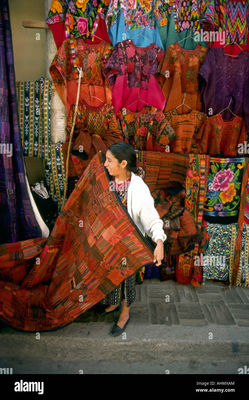 Guatemala Highlands textiles Chichicastenango market stallholder showing woven fabric Stock Photo