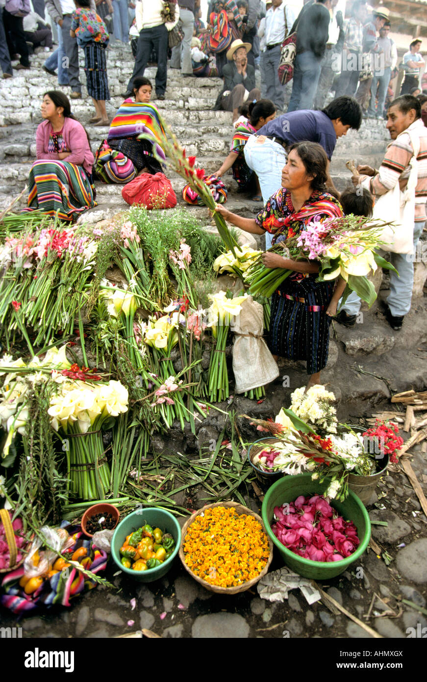 Guatemala Highlands Chichicastenango market Santo Tomás Church steps flower stall woman selling gladioli Stock Photo