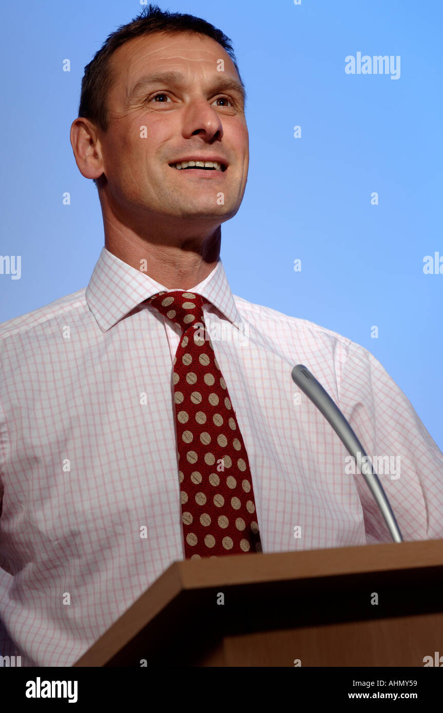 Businessman speaking at a podium Stock Photo