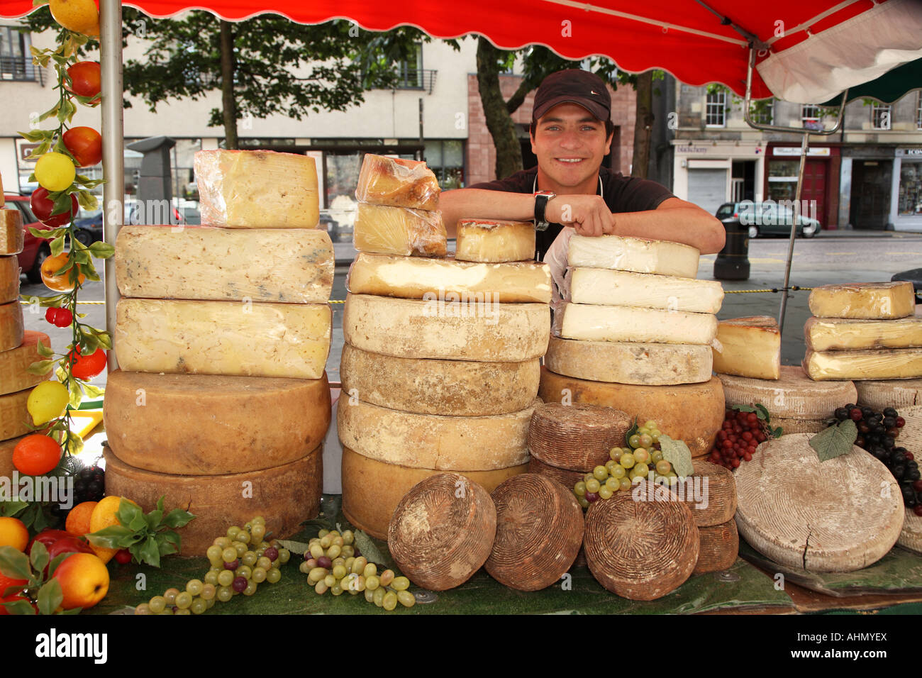 Man selling selection of Italian cheeses from Market stall in Grassmarket Edinburgh Scotland Stock Photo