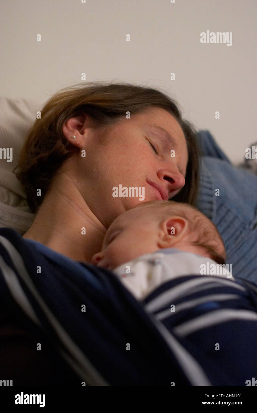 mother sleeping, with baby in sling Stock Photo Alamy